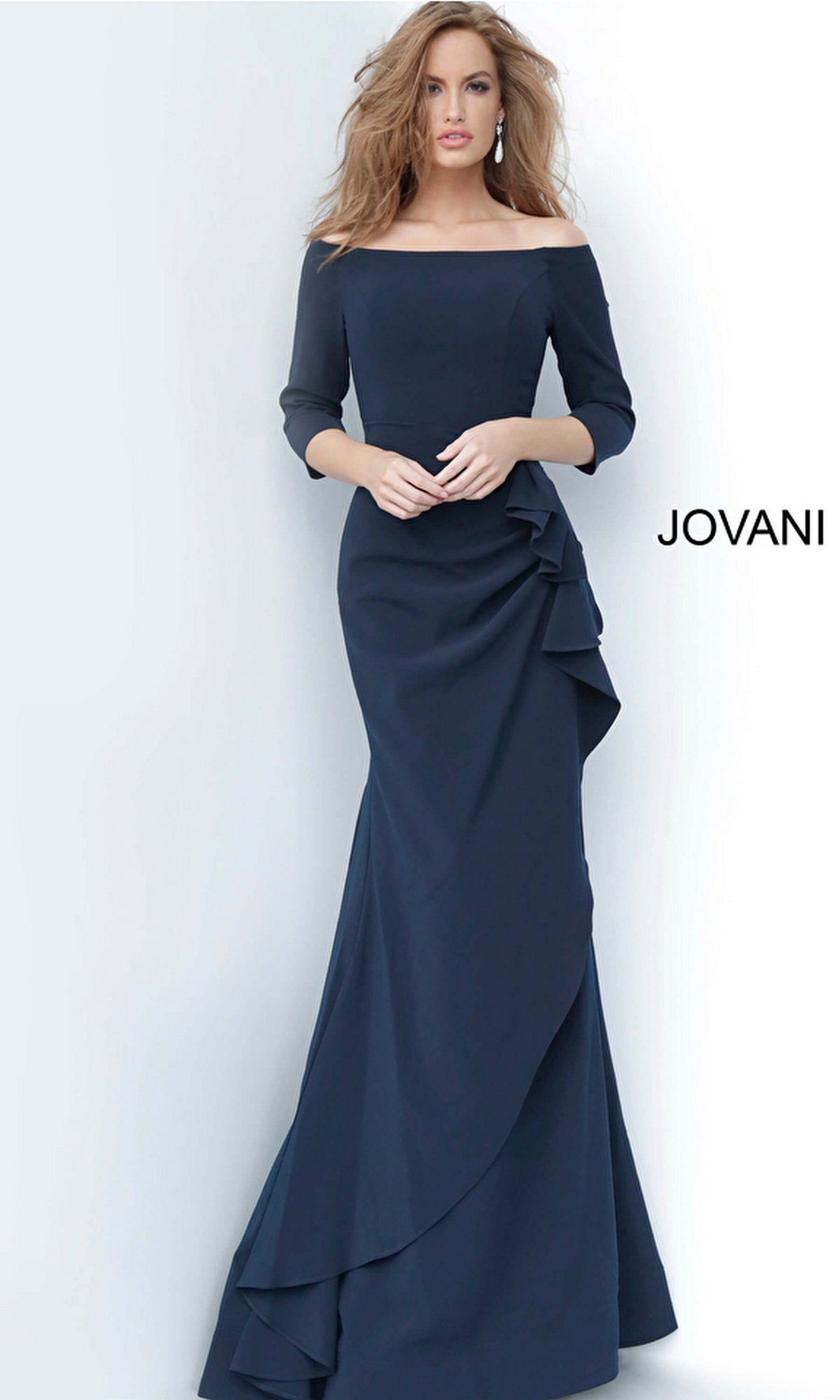 A woman wears the Jovani Mother-of-the-Bride Long Formal Dress 00446 in navy, featuring off-the-shoulder three-quarter sleeves with ruffle details, set against a plain white background with the Jovani logo—an elegant occasion look.